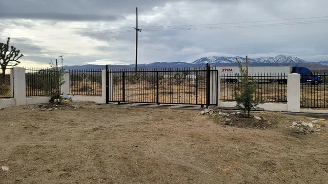 a view of a dirt road with a building in the background