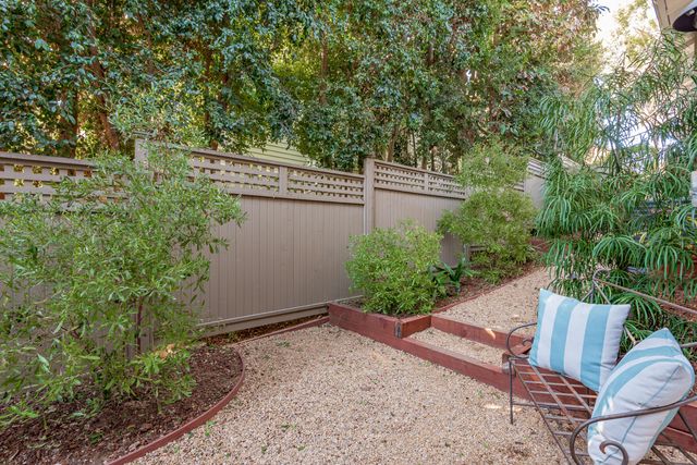 a view of backyard with outdoor seating and green space
