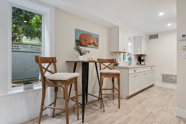 a view of a dining room with furniture and window