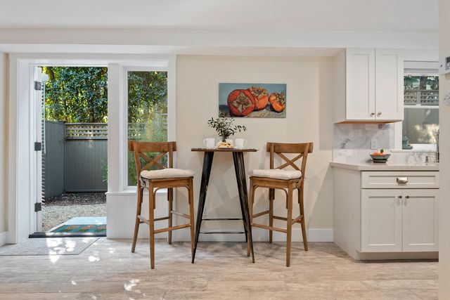 a view of a dining room with windows and wooden floor