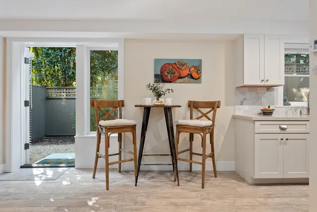 a view of a dining room with windows and wooden floor