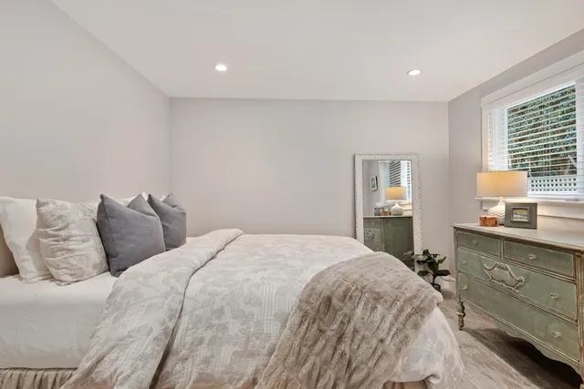 a bedroom with a bed and a table in it