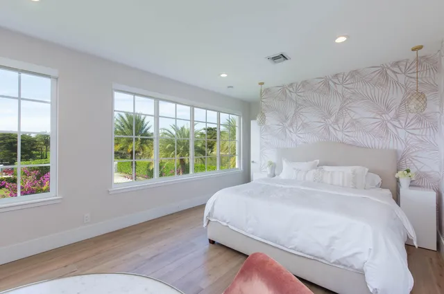 a bedroom with a large bed and a large window