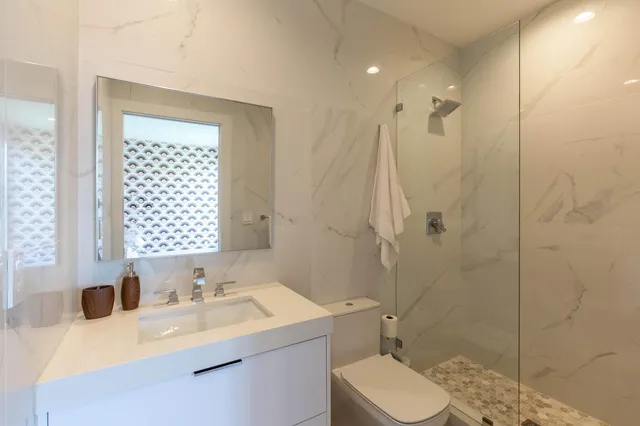 a bathroom with a sink toilet and shower