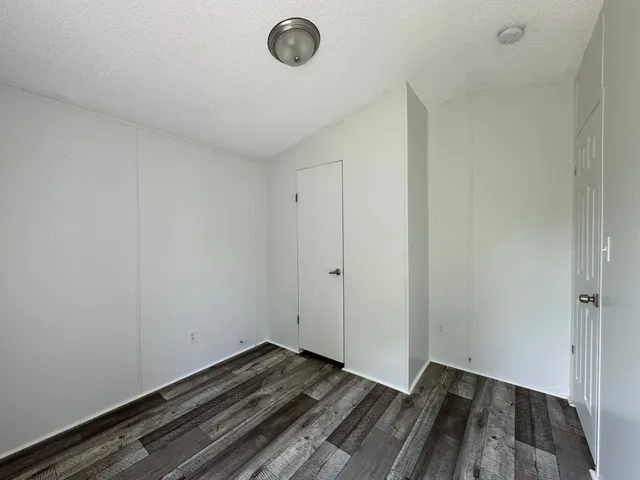 a view of a room with wooden floor