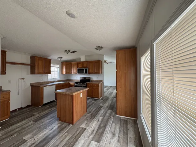 a kitchen with stainless steel appliances granite countertop a stove and a sink