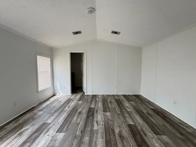 a view of a room with wooden floor