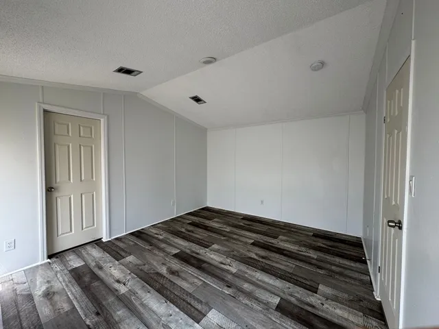 a view of a room with wooden floor