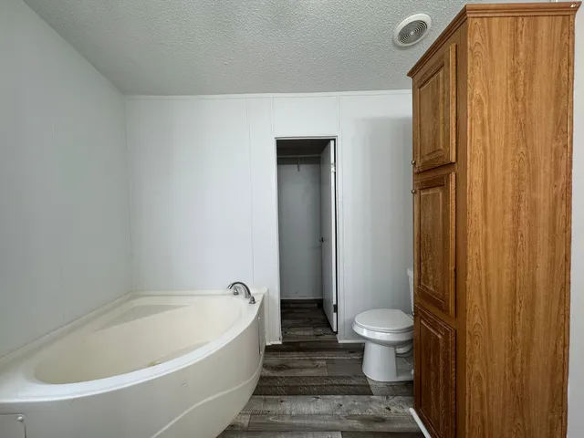 a bathroom with a bathtub and toilet