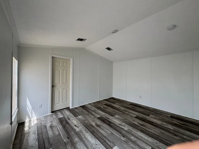 a view of a room with wooden floor