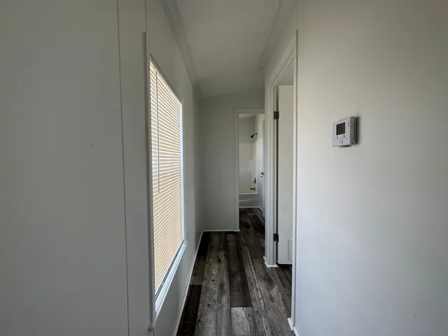 a view of a hallway with a hardwood floor