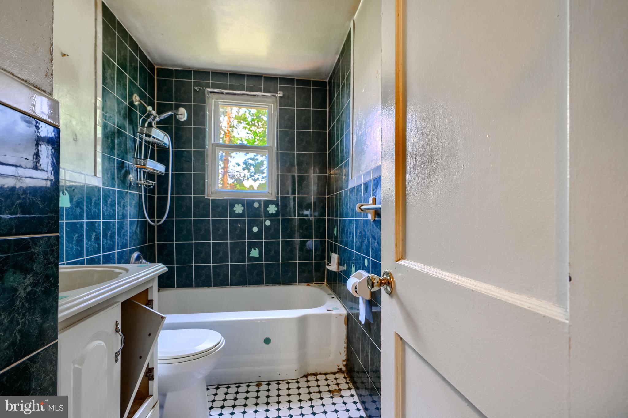 2837 Round Road Baltimore, MD 21225 - Photo 12 of 18 a bathroom with a bathtub a toilet and a shower
