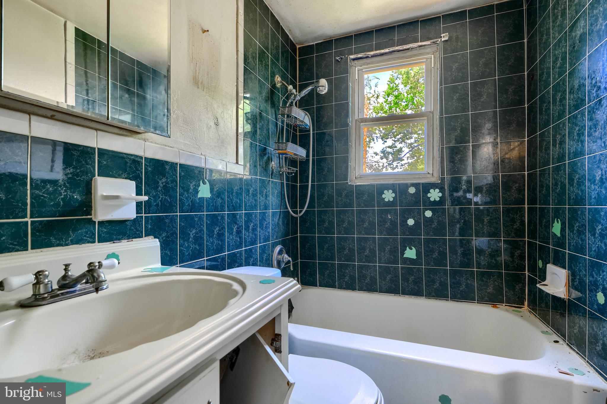 2837 Round Road Baltimore, MD 21225 - Photo 13 of 18 a bathroom with a tub a sink and window