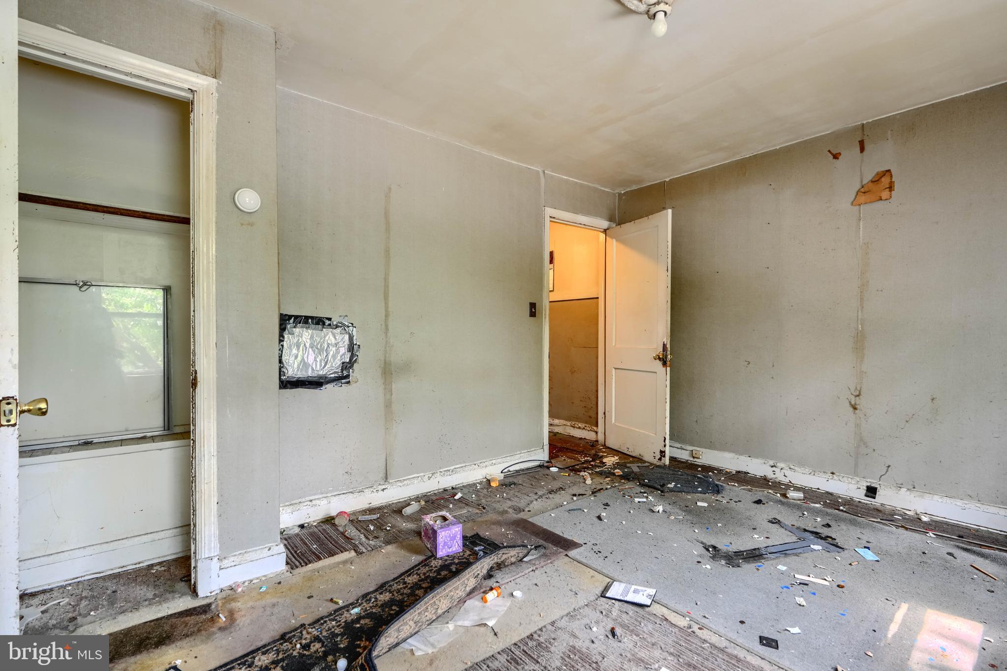 2837 Round Road Baltimore, MD 21225 - Photo 8 of 18 a bedroom with a bed and wooden floor