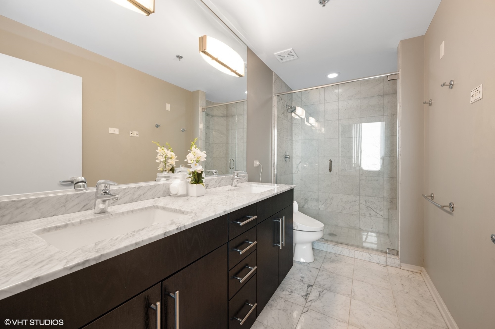 123 South Green Street, Unit 201B Chicago, IL 60607 - Photo 12 of 19 a bathroom with a granite countertop sink a toilet and a shower