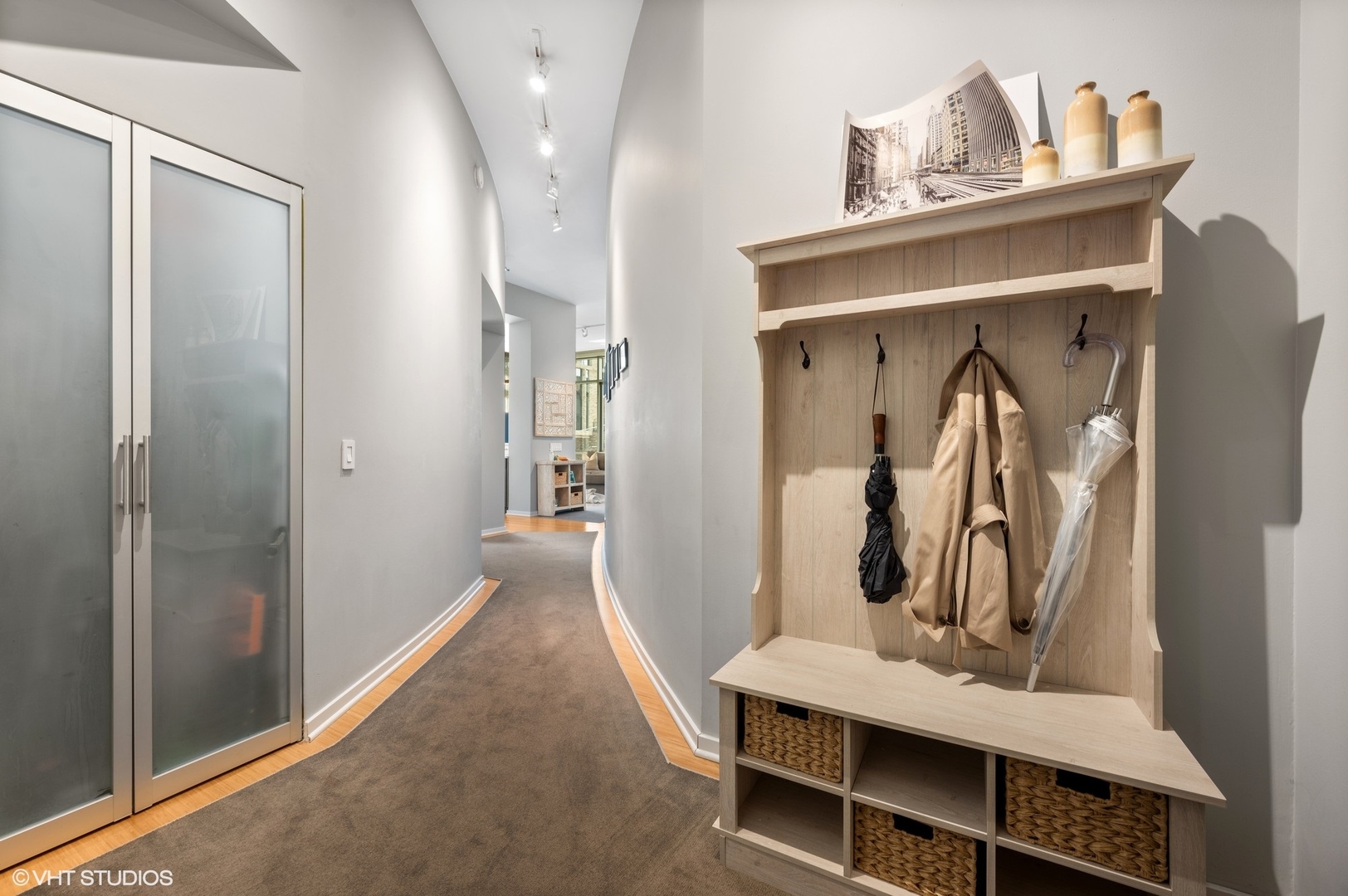 123 South Green Street, Unit 201B Chicago, IL 60607 - Photo 4 of 19 a view of a hallway with wooden floor and a cabinet