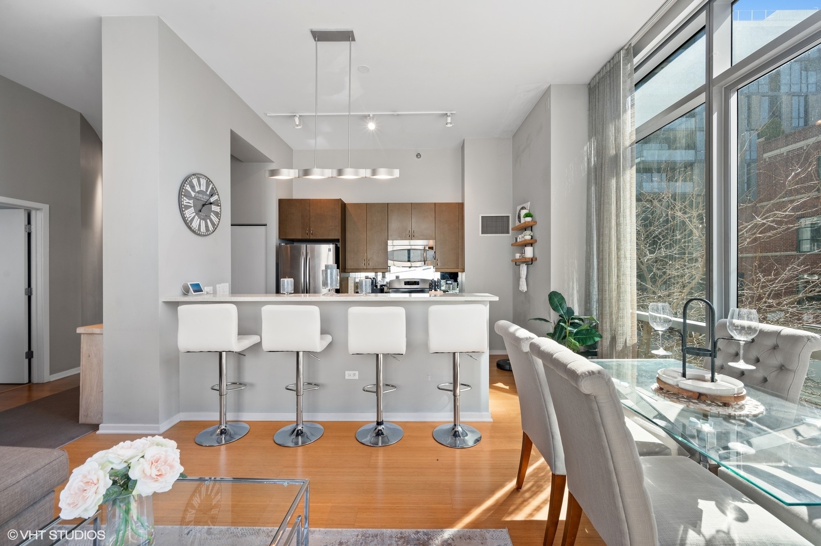 123 South Green Street, Unit 201B Chicago, IL 60607 - Photo 9 of 19 a living room with kitchen island furniture and a large window