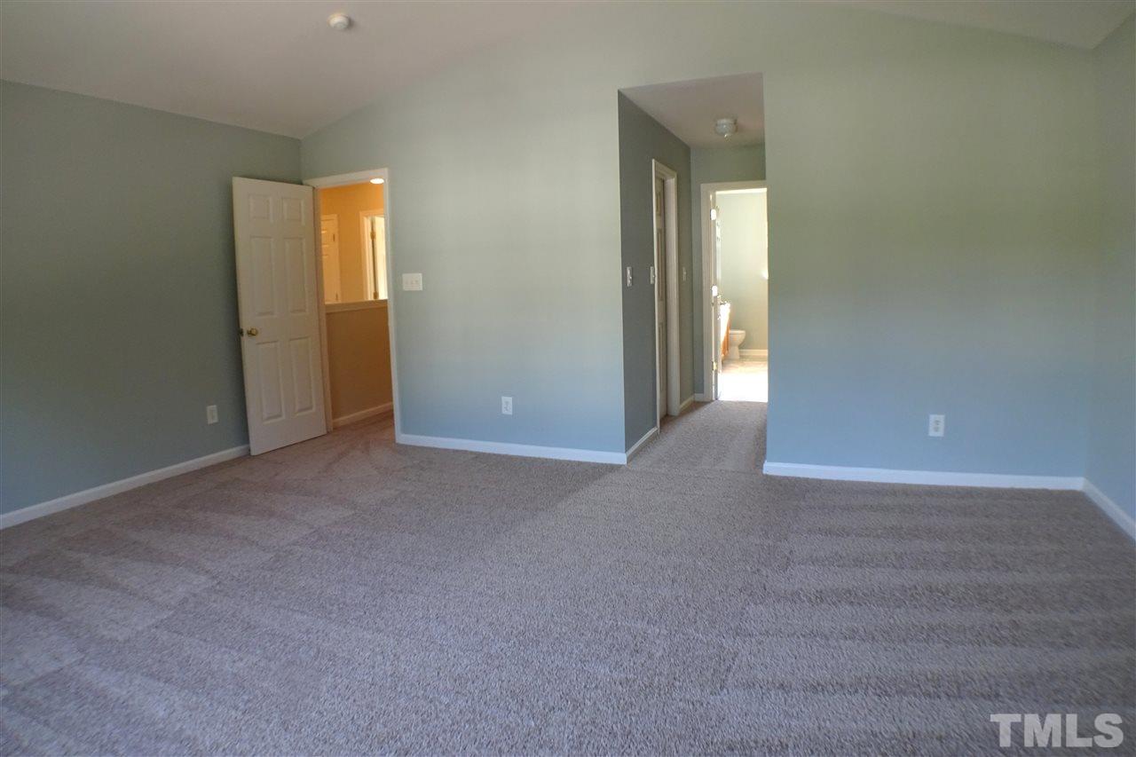 3813 Tyler Bluff Lane Raleigh, NC 27616 - Photo 14 of 25 a view of an empty room with a bathroom