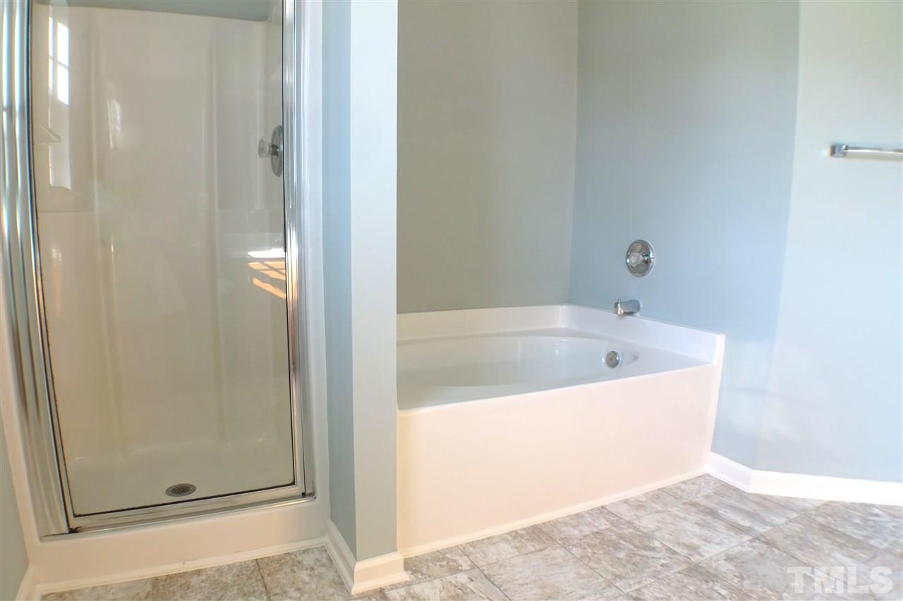 3813 Tyler Bluff Lane Raleigh, NC 27616 - Photo 16 of 25 a white bath tub sitting next to a window