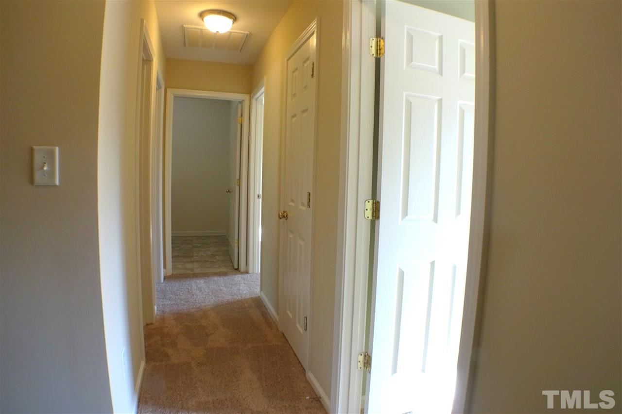 3813 Tyler Bluff Lane Raleigh, NC 27616 - Photo 17 of 25 a view of a bathroom from a hallway
