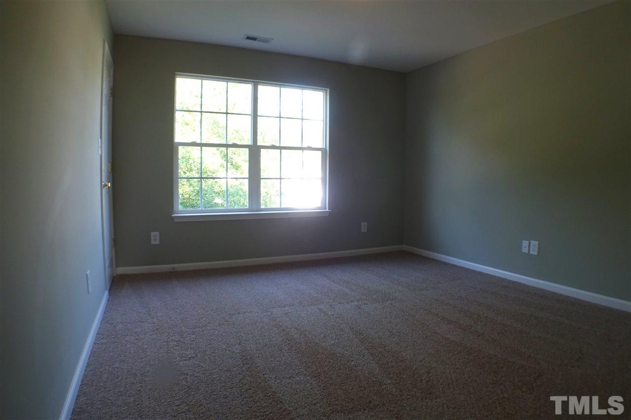 3813 Tyler Bluff Lane Raleigh, NC 27616 - Photo 18 of 25 an empty room with a window