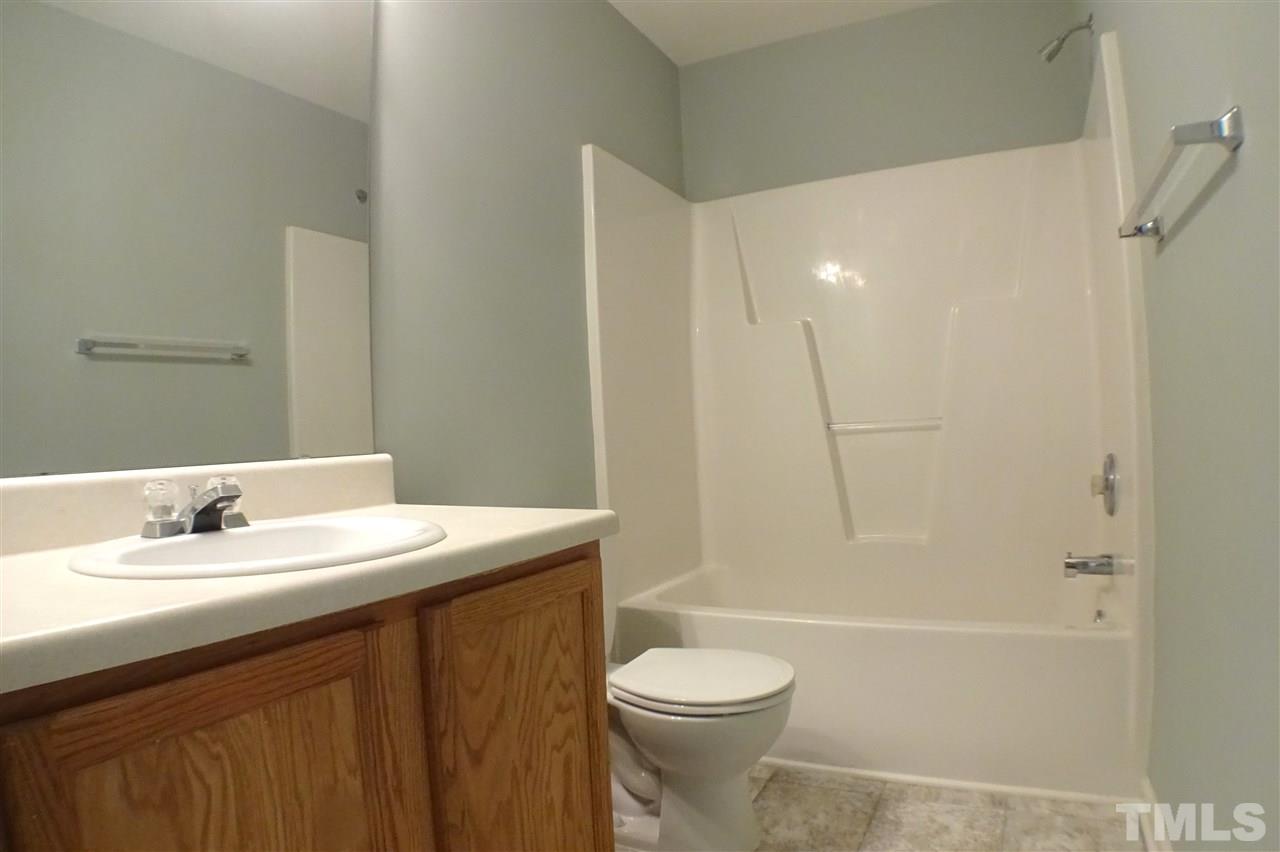 3813 Tyler Bluff Lane Raleigh, NC 27616 - Photo 19 of 25 a bathroom with a sink a toilet and shower