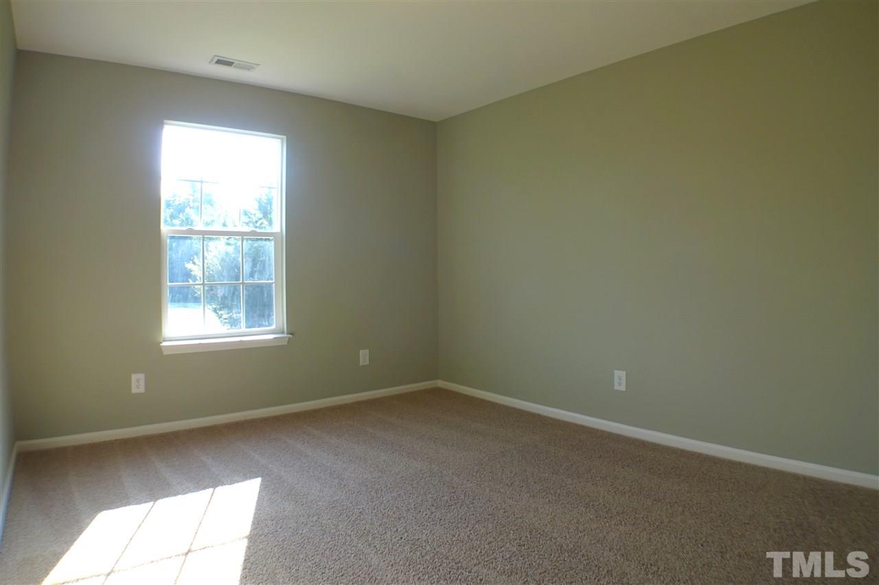 3813 Tyler Bluff Lane Raleigh, NC 27616 - Photo 21 of 25 an empty room with a window