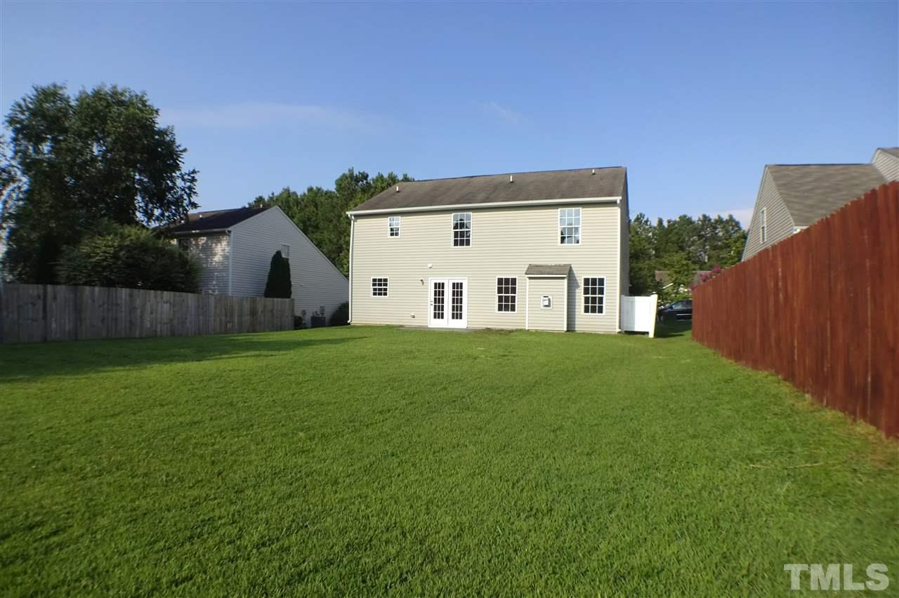 3813 Tyler Bluff Lane Raleigh, NC 27616 - Photo 24 of 25 a view of a house with a big yard with wooden fence