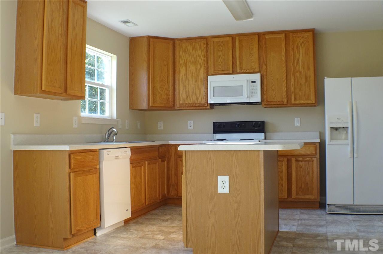 3813 Tyler Bluff Lane Raleigh, NC 27616 - Photo 4 of 25 a kitchen with a refrigerator sink and cabinets