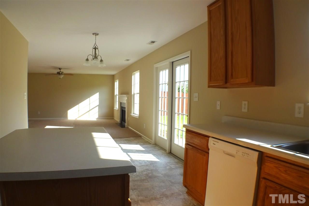 3813 Tyler Bluff Lane Raleigh, NC 27616 - Photo 6 of 25 a view of an empty room with window and a kitchen