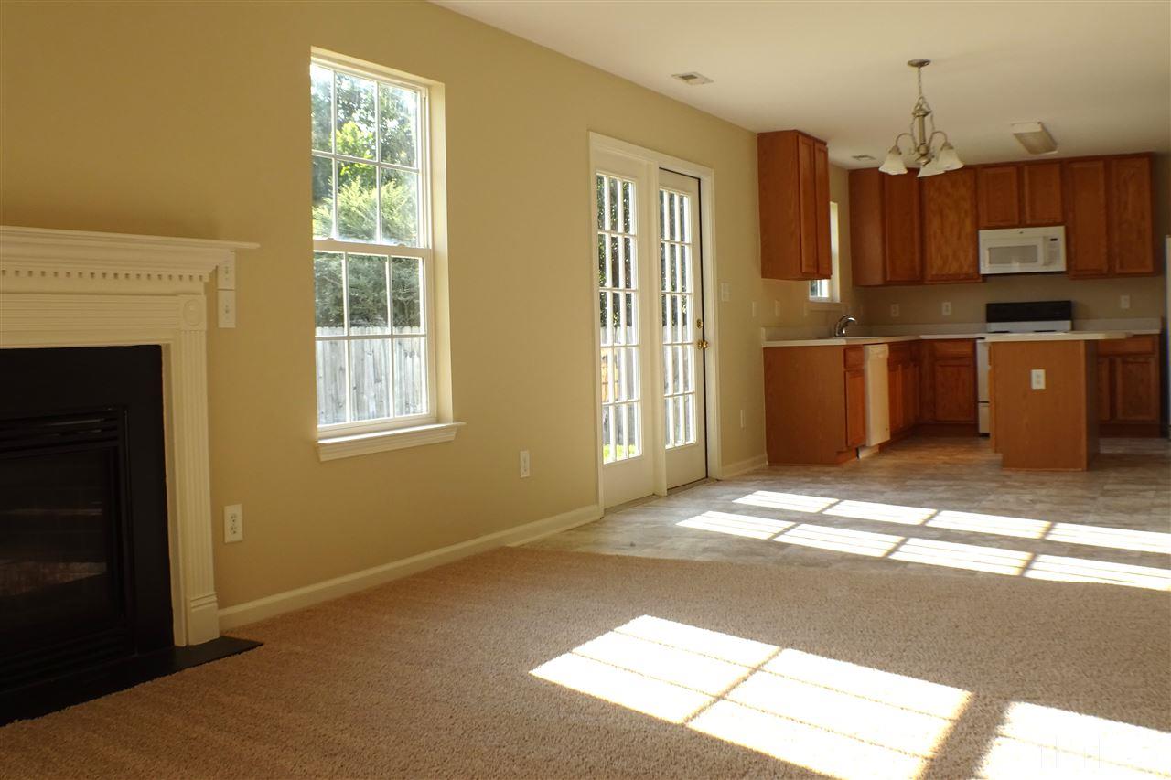 3813 Tyler Bluff Lane Raleigh, NC 27616 - Photo 8 of 25 a kitchen with stainless steel appliances granite countertop a refrigerator a stove a sink and a window