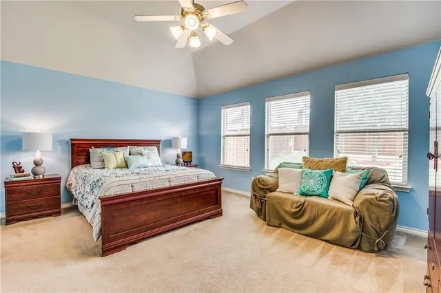 a spacious bedroom with a bed and window