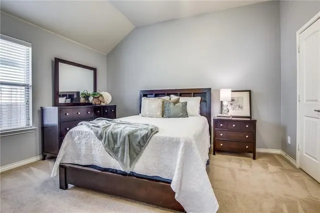 a bedroom with a bed and window