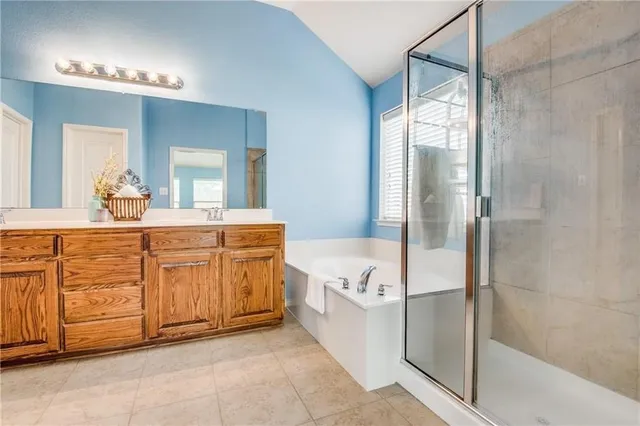 a spacious bathroom with a granite countertop sink mirror and bathtub