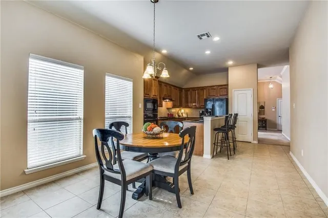 a dining room with furniture and a chandelier