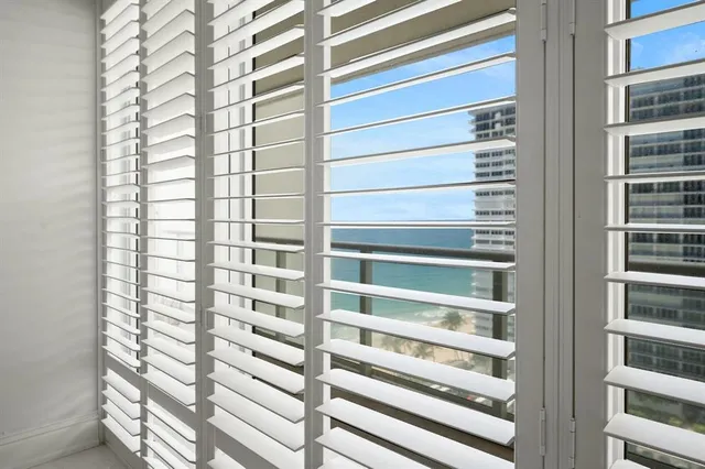 a bathroom with a toilet sink vanity granite and shower