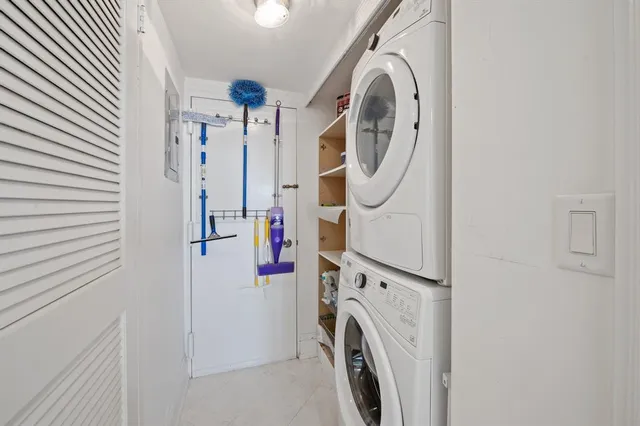 a living room with furniture and large windows