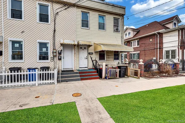 a front view of a house with a yard table and chairs