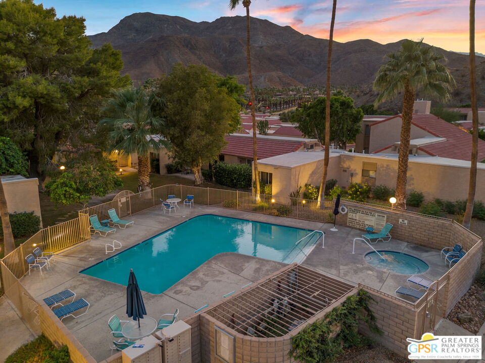 70100 Mirage Cove Drive, Unit 10 Rancho Mirage, CA 92270 - Photo 24 of 68 a view of a patio with couches table and chairs with wooden floor and fence