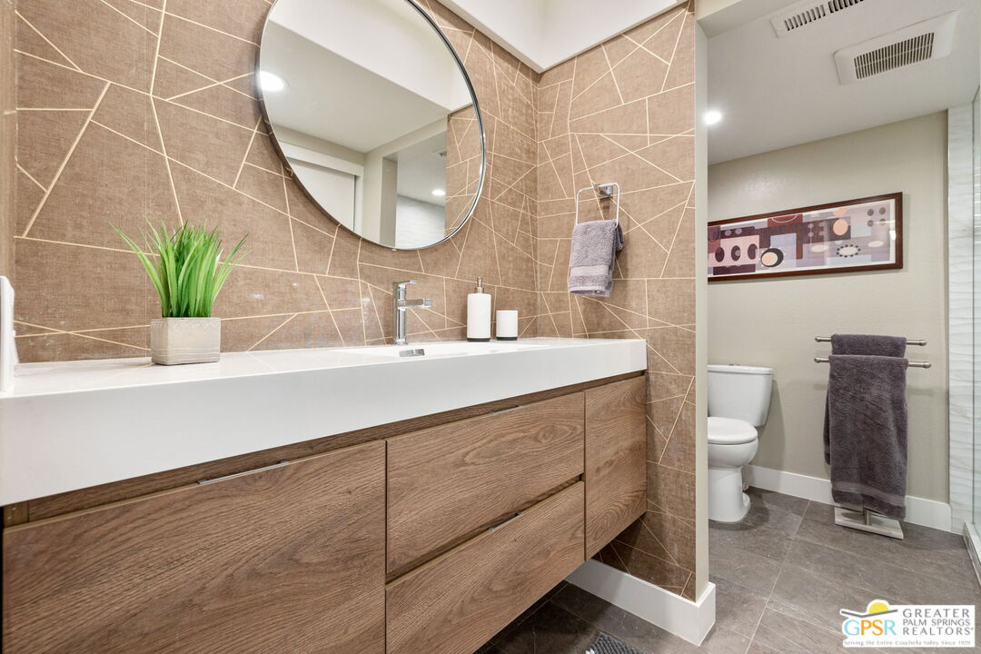 70100 Mirage Cove Drive, Unit 10 Rancho Mirage, CA 92270 - Photo 33 of 68 a bathroom with a sink mirror and toilet