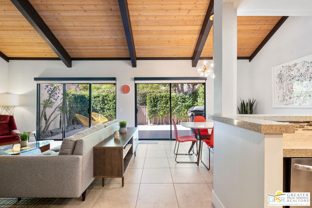 70100 Mirage Cove Drive, Unit 10 Rancho Mirage, CA 92270 - Photo 35 of 68 a living room with furniture and a large window