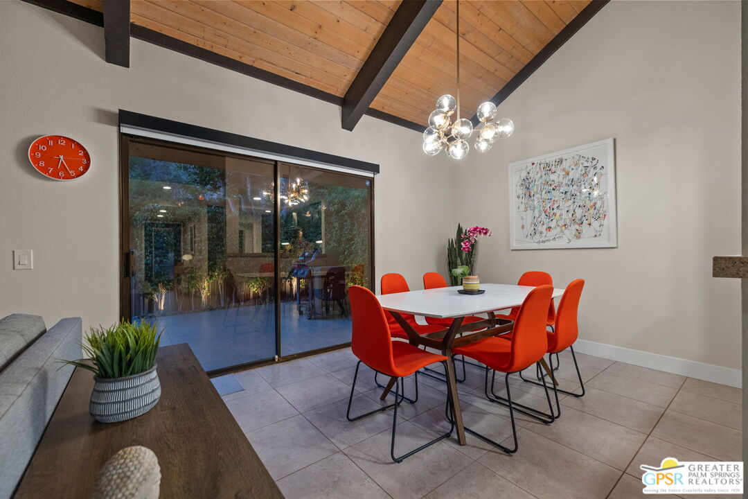 70100 Mirage Cove Drive, Unit 10 Rancho Mirage, CA 92270 - Photo 4 of 68 a dining room with furniture potted plants and a chandelier