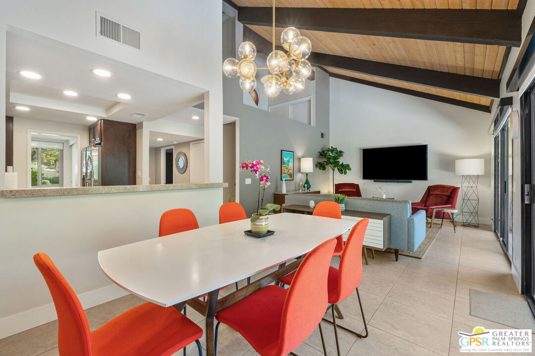 70100 Mirage Cove Drive, Unit 10 Rancho Mirage, CA 92270 - Photo 42 of 68 a view of a dining room with furniture and a flat screen tv
