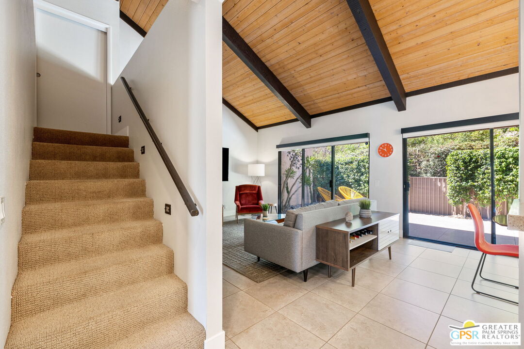 70100 Mirage Cove Drive, Unit 10 Rancho Mirage, CA 92270 - Photo 48 of 68 a living room with furniture and large windows