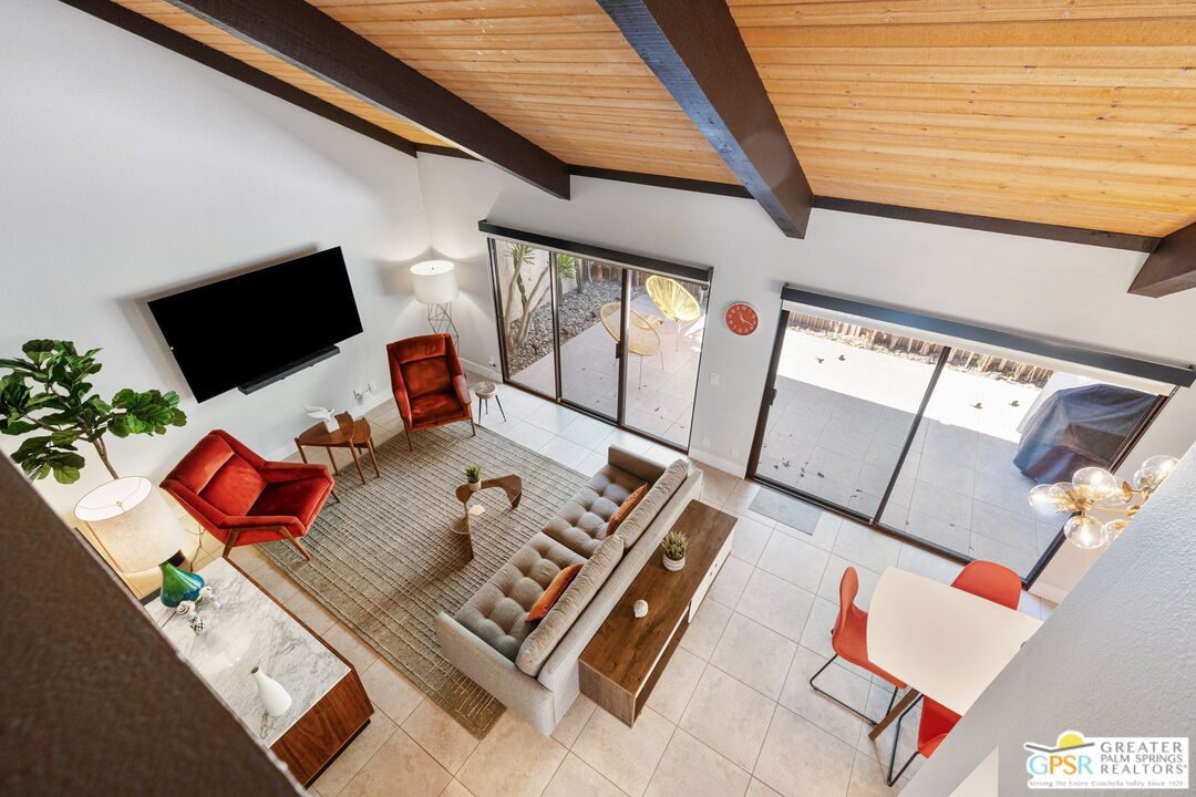 70100 Mirage Cove Drive, Unit 10 Rancho Mirage, CA 92270 - Photo 50 of 68 a living room with furniture and a flat screen tv