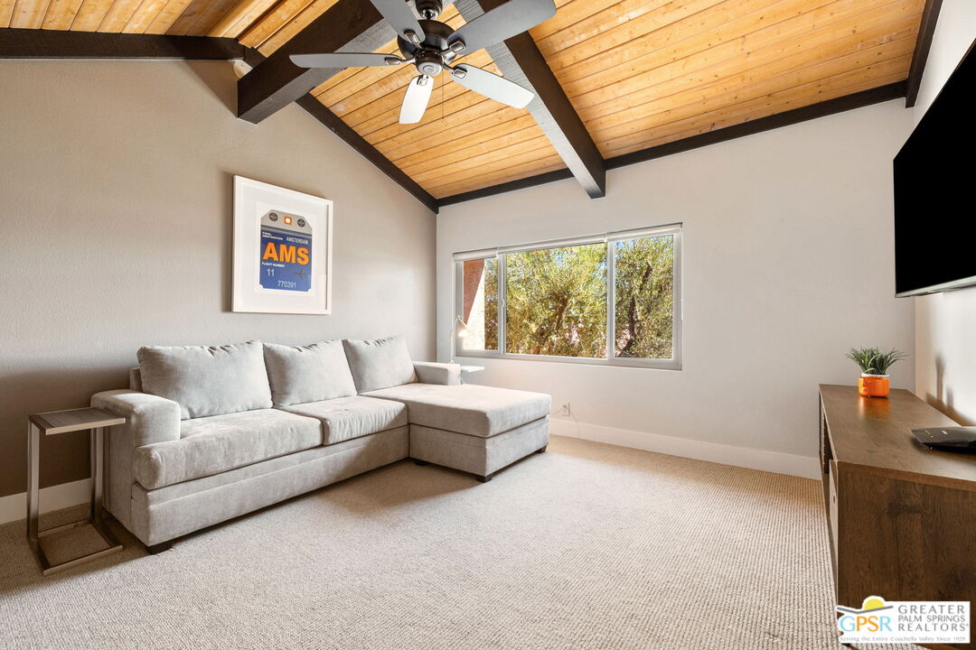 70100 Mirage Cove Drive, Unit 10 Rancho Mirage, CA 92270 - Photo 51 of 68 a living room with furniture a flat screen tv and a window