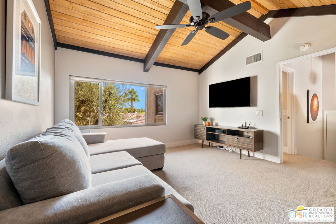 70100 Mirage Cove Drive, Unit 10 Rancho Mirage, CA 92270 - Photo 52 of 68 a living room with furniture and a flat screen tv