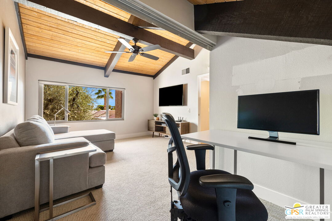 70100 Mirage Cove Drive, Unit 10 Rancho Mirage, CA 92270 - Photo 53 of 68 a living room with furniture and a flat screen tv