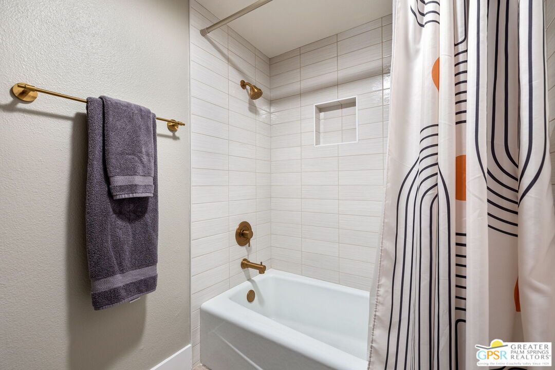 70100 Mirage Cove Drive, Unit 10 Rancho Mirage, CA 92270 - Photo 58 of 68 a bathroom with a bathtub and a shower