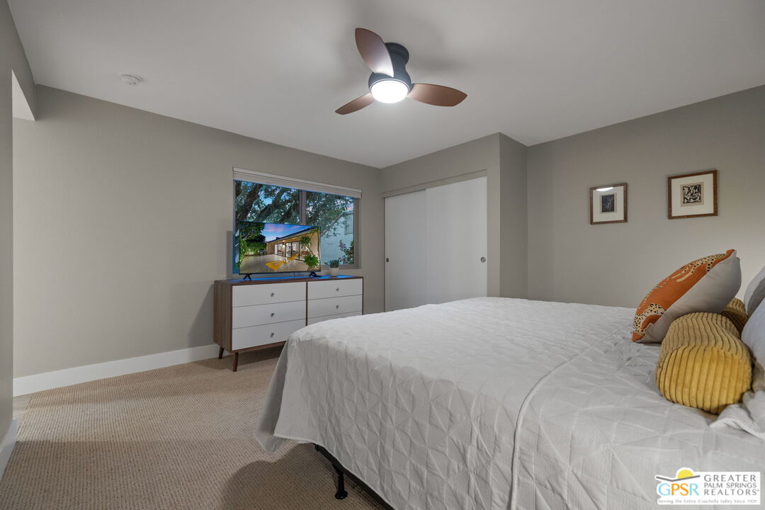 70100 Mirage Cove Drive, Unit 10 Rancho Mirage, CA 92270 - Photo 9 of 68 a bedroom with a bed and a chandelier